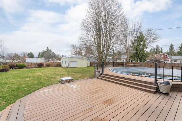 deck with a fenced backyard, an outdoor structure, a fenced in pool, and a lawn