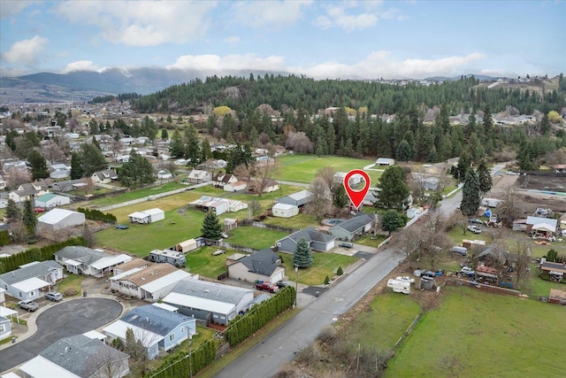 bird's eye view featuring a view of trees, a mountain view, and a residential view