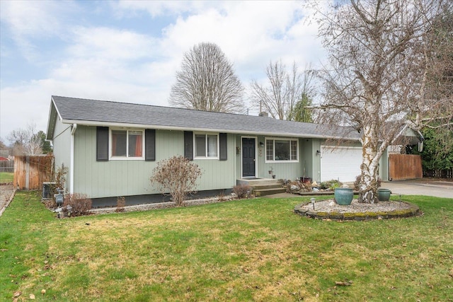 ranch-style house featuring an attached garage, aphalt driveway, a front yard, and fence