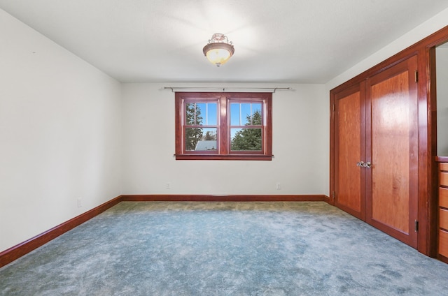 unfurnished bedroom with baseboards and carpet
