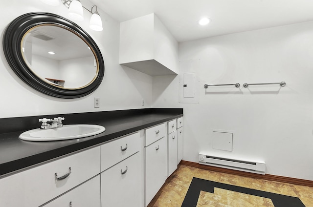 bathroom with vanity, baseboard heating, and baseboards