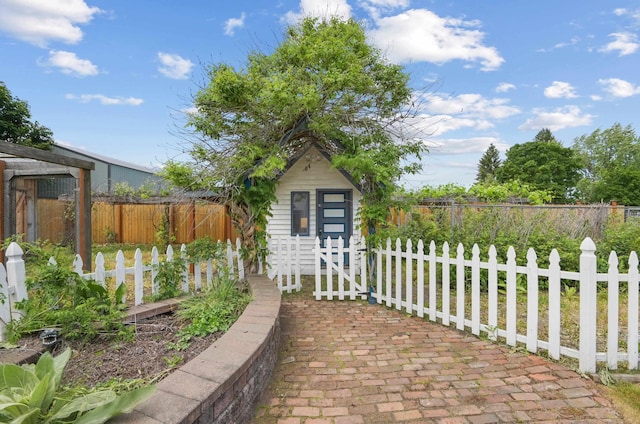 view of patio / terrace with a shed, fence private yard, and an outdoor structure