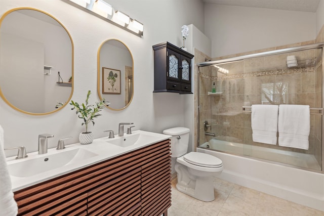bathroom with toilet, enclosed tub / shower combo, double vanity, and tile patterned flooring