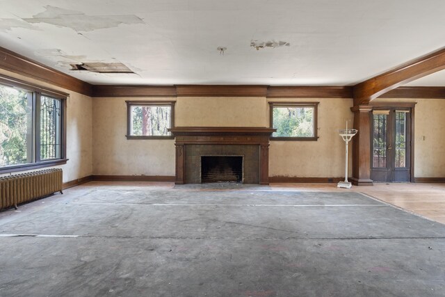540 E Rockwood Blvd, Spokane, WA 99202 - unfurnished living room with radiator, a fireplace, baseboards, and concrete floors