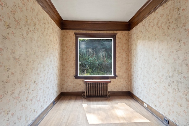 540 E Rockwood Blvd, Spokane, WA 99202 - unfurnished room with baseboards, ornamental molding, wood finished floors, wallpapered walls, and radiator heating unit