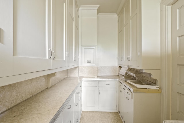 540 E Rockwood Blvd, Spokane, WA 99202 - kitchen featuring tasteful backsplash, light countertops, white cabinetry, and crown molding
