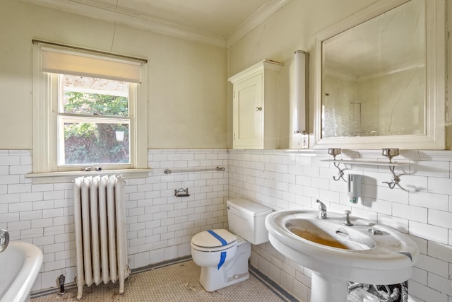 540 E Rockwood Blvd, Spokane, WA 99202 - bathroom featuring tile patterned floors, crown molding, toilet, radiator heating unit, and tile walls