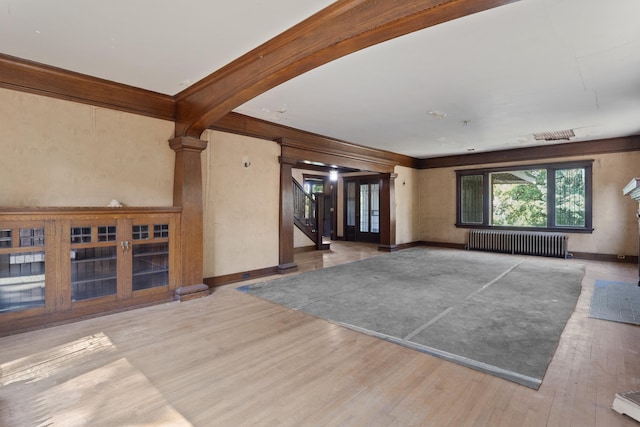 540 E Rockwood Blvd, Spokane, WA 99202 - unfurnished living room with baseboards, beamed ceiling, stairway, radiator, and wood finished floors