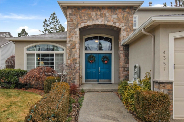 4357 S Greystone Ln, Spokane, WA 99203 - doorway to property with stucco siding, stone siding, and an attached garage