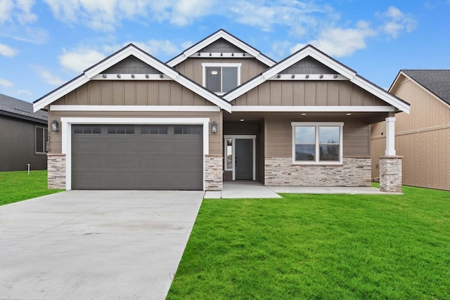 13310 N Starling Ln, Spokane, WA 99208 - craftsman-style house with driveway, a front yard, stone siding, and a garage