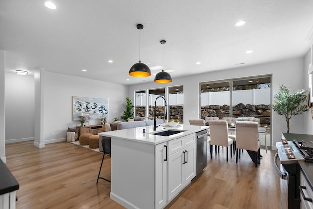13310 N Starling Ln, Spokane, WA 99208 - kitchen with a sink, open floor plan, appliances with stainless steel finishes, and light wood finished floors