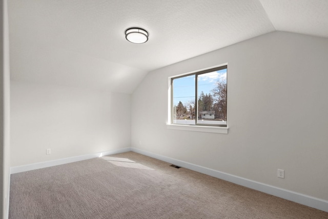 13310 N Starling Ln, Spokane, WA 99208 - additional living space with a textured ceiling, visible vents, carpet floors, lofted ceiling, and baseboards