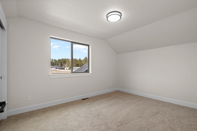 13310 N Starling Ln, Spokane, WA 99208 - additional living space featuring carpet flooring, visible vents, baseboards, and vaulted ceiling