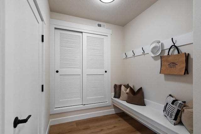 13310 N Starling Ln, Spokane, WA 99208 - mudroom with visible vents, baseboards, a textured ceiling, and wood finished floors