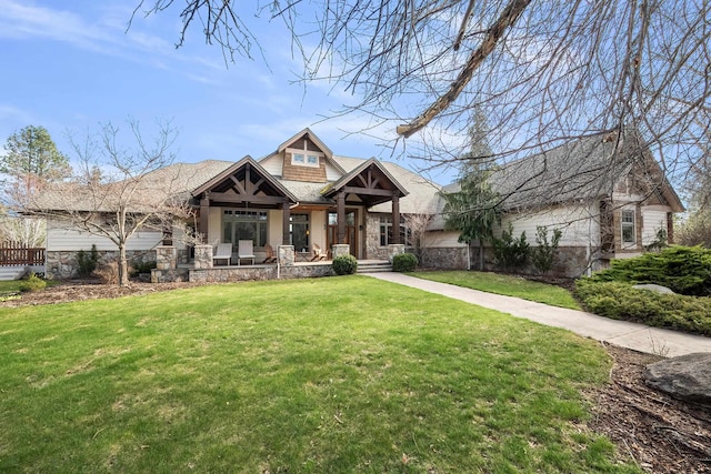 13615 N Riverbluff Ln, Spokane, WA 99208 - craftsman-style home with a front yard, a shingled roof, and stone siding