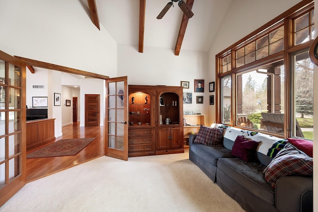 13615 N Riverbluff Ln, Spokane, WA 99208 - living area featuring french doors, carpet floors, visible vents, beamed ceiling, and high vaulted ceiling