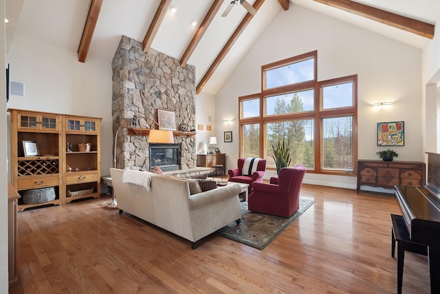 13615 N Riverbluff Ln, Spokane, WA 99208 - living room with wood finished floors, ceiling fan, beam ceiling, and a stone fireplace