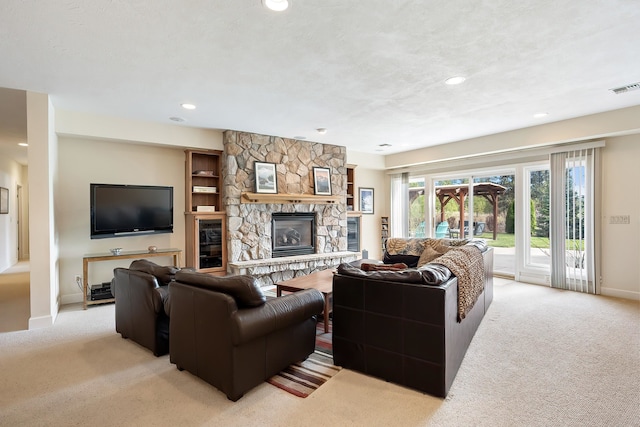 13615 N Riverbluff Ln, Spokane, WA 99208 - living area featuring wine cooler, visible vents, light carpet, and a fireplace