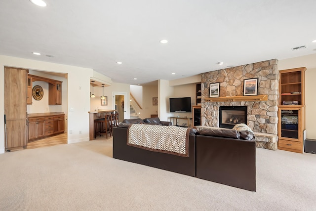 13615 N Riverbluff Ln, Spokane, WA 99208 - living room with light carpet, bar area, a fireplace, and recessed lighting