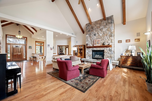 13615 N Riverbluff Ln, Spokane, WA 99208 - living room with visible vents, a stone fireplace, beamed ceiling, light wood-style flooring, and high vaulted ceiling