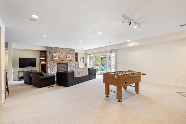 13615 N Riverbluff Ln, Spokane, WA 99208 - recreation room featuring visible vents, baseboards, a stone fireplace, recessed lighting, and light colored carpet