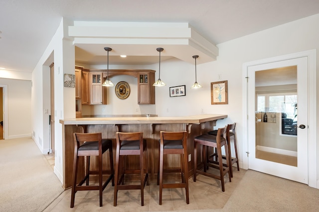 13615 N Riverbluff Ln, Spokane, WA 99208 - bar featuring indoor wet bar, decorative light fixtures, light colored carpet, and baseboards