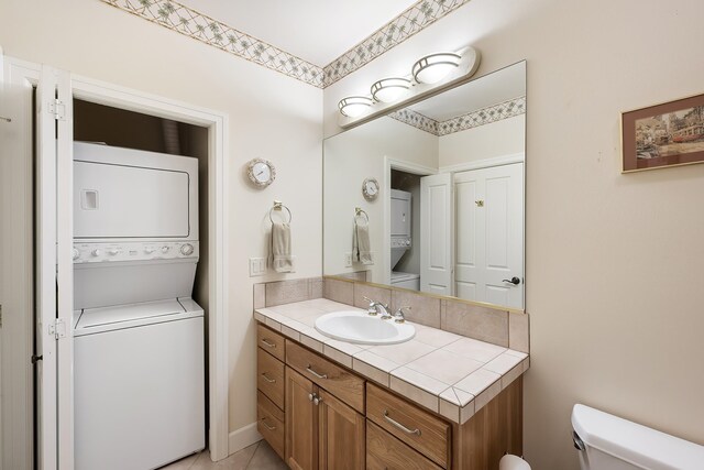 13615 N Riverbluff Ln, Spokane, WA 99208 - half bathroom with toilet, stacked washing maching and dryer, and vanity