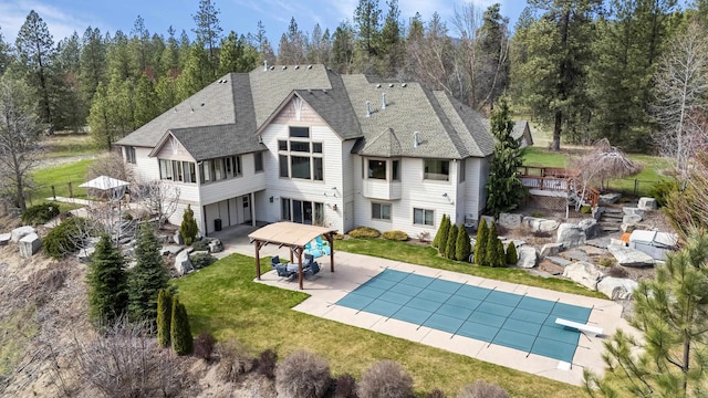 13615 N Riverbluff Ln, Spokane, WA 99208 - back of house featuring a yard, a covered pool, fence, stairway, and a patio