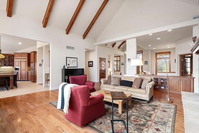 13615 N Riverbluff Ln, Spokane, WA 99208 - living room featuring light wood-style floors, high vaulted ceiling, visible vents, and beamed ceiling