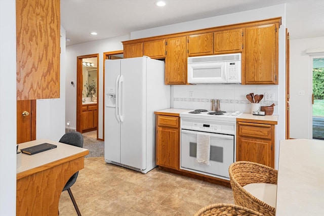 2603 S Sunnybrook Ln, Spokane, WA 99037 - kitchen with white appliances, brown cabinets, light countertops, backsplash, and recessed lighting