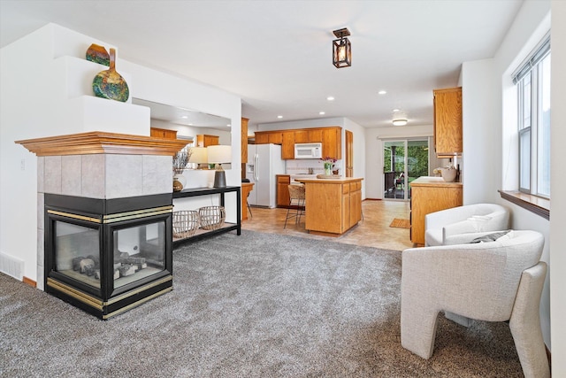 2603 S Sunnybrook Ln, Spokane, WA 99037 - living area featuring light colored carpet, recessed lighting, and a tile fireplace