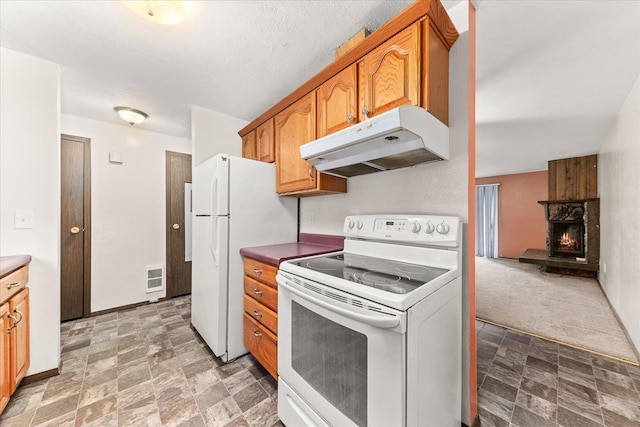 2121 E Upriver Dr Unit # 61, Spokane, WA 99207 - kitchen featuring white appliances, stone finish floor, a stone fireplace, visible vents, and under cabinet range hood