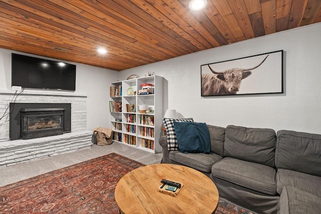 living area featuring wood ceiling, a stone fireplace, carpet, and recessed lighting