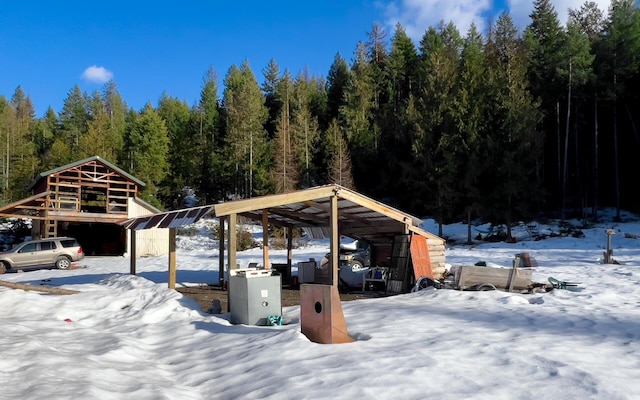 2467 Widow Rd Unit D, Colville, WA 99114 - snow covered parking with a wooded view