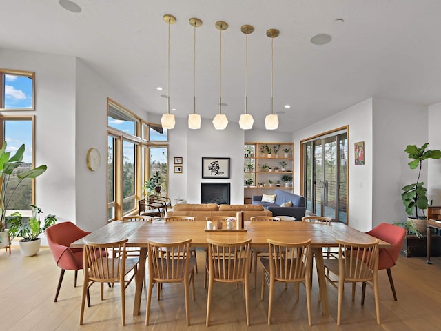 dining area featuring a wealth of natural light, a fireplace, light wood-type flooring, and recessed lighting