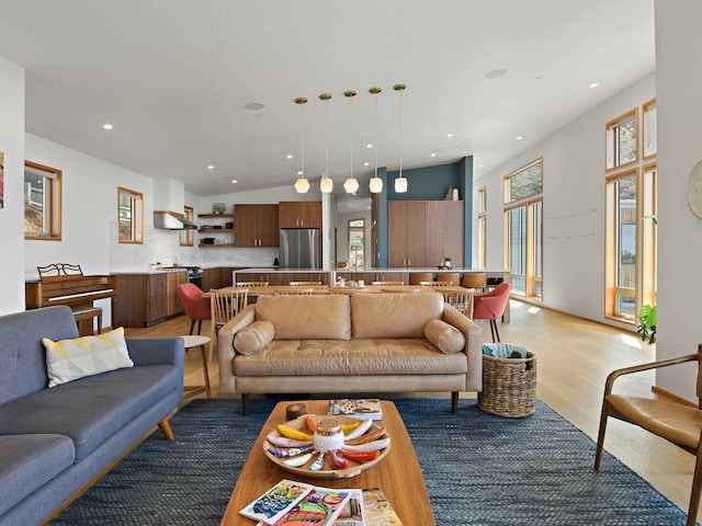 living room with light wood-style flooring and recessed lighting