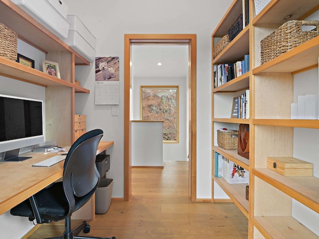 office space featuring baseboards and wood finished floors