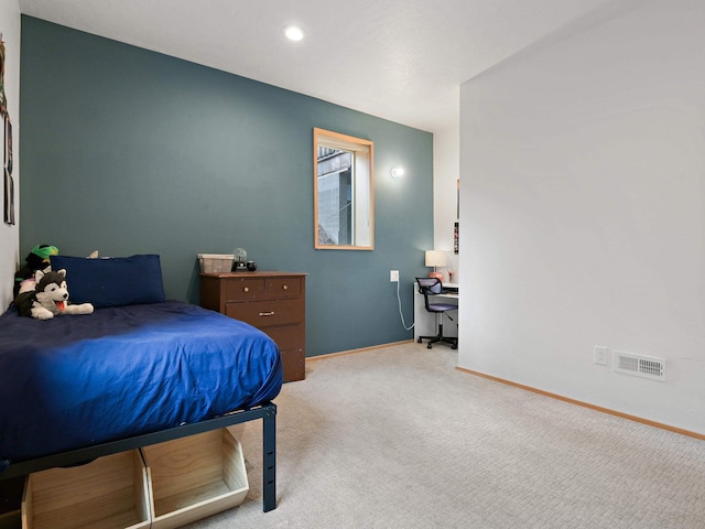 bedroom featuring visible vents, baseboards, and light carpet