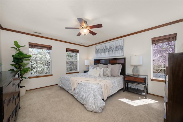 bedroom featuring baseboards, visible vents, crown molding, and light colored carpet
