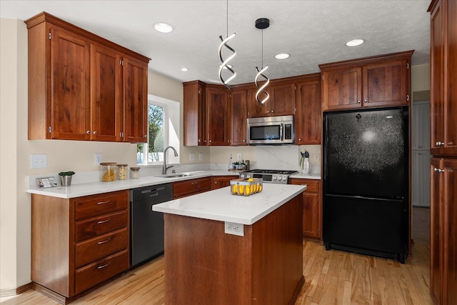 kitchen with recessed lighting, a sink, light wood-type flooring, black appliances, and light countertops