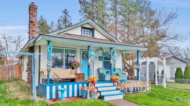 641 S Denver St, Spokane, WA 99202 - view of front of home featuring a porch, a chimney, and a shingled roof