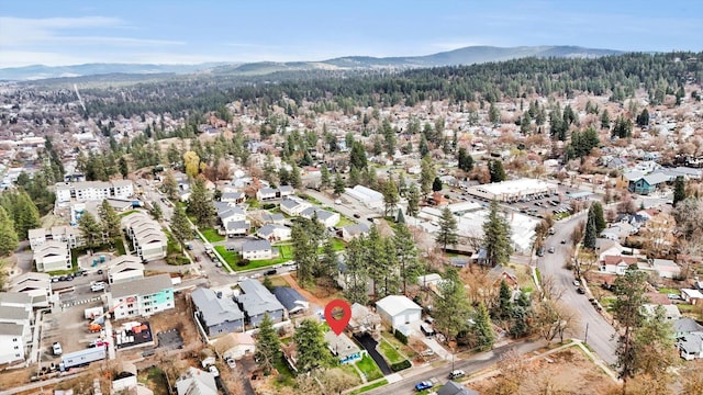 641 S Denver St, Spokane, WA 99202 - aerial overview of property's location featuring a mountain backdrop and a heavily wooded area