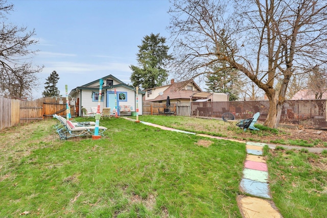view of yard with an outbuilding and a fenced backyard