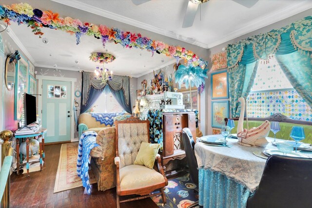dining area featuring ornamental molding, wood-type flooring, and ceiling fan with notable chandelier