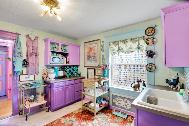 kitchen with tasteful backsplash, a textured ceiling, a sink, and open shelves