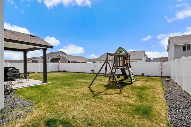 view of yard featuring a fenced backyard, a patio area, and a playground