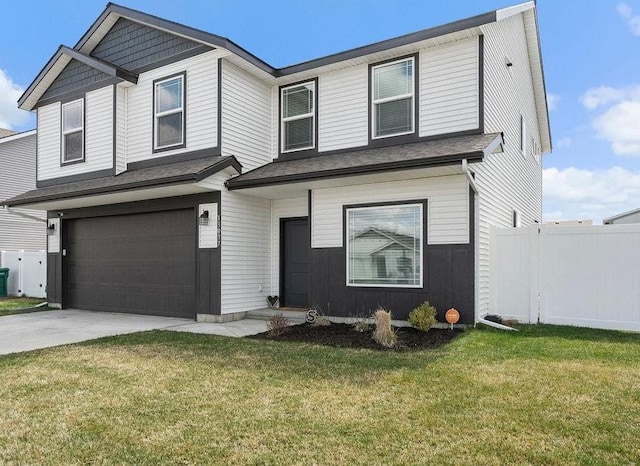 view of front of home featuring fence, an attached garage, driveway, and a front lawn