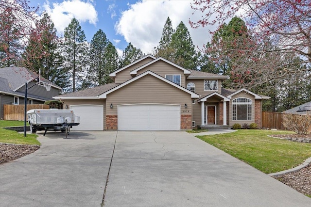 view of front of house featuring a front yard, fence, brick siding, an attached garage, and driveway