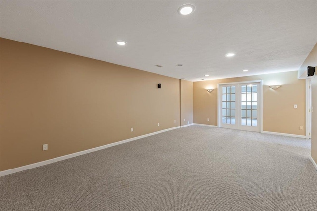 unfurnished room with light carpet, recessed lighting, baseboards, and a textured ceiling