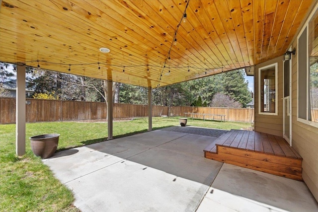 view of patio / terrace featuring a fenced backyard and a trampoline